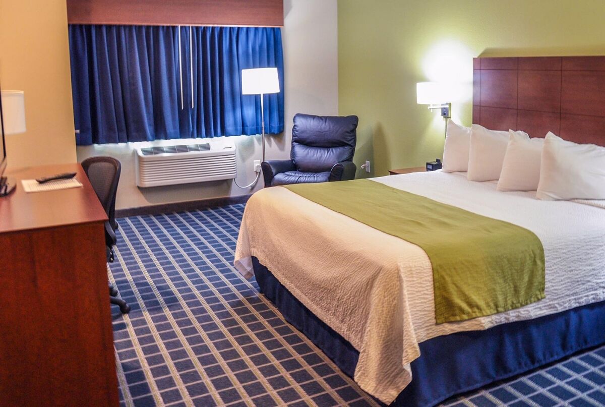 Executive king room with a king bed, leather recliner and work desk