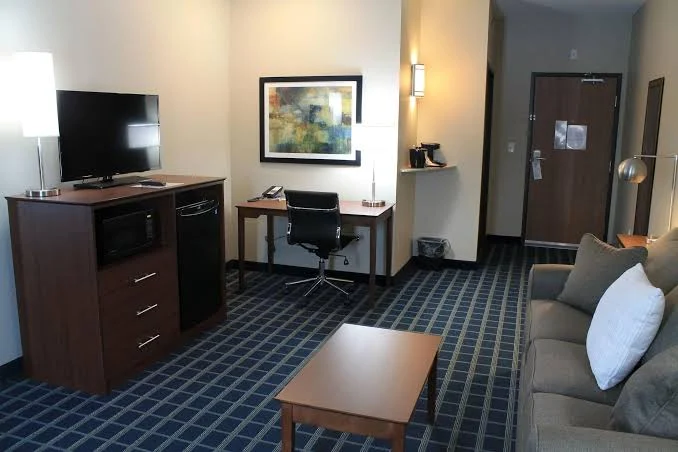 King suite with a separate living area, sofa, coffee table and wet bar